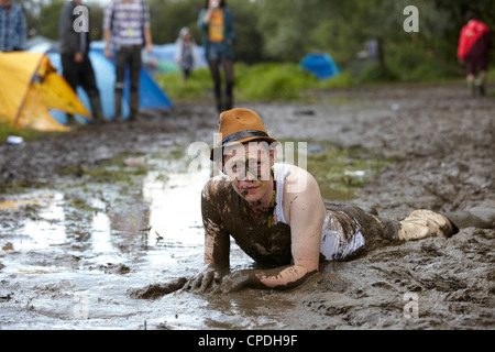 Boys playing in mud at music festival in the UK Stock Photo