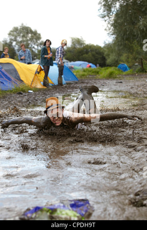 Boys playing in mud at music festival in the UK Stock Photo