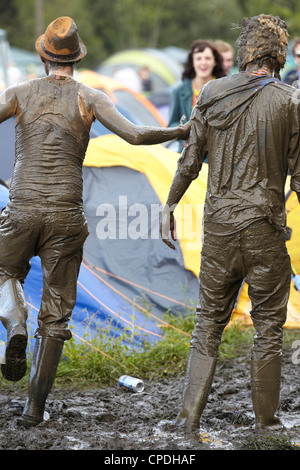 Boys playing in mud at music festival in the UK Stock Photo