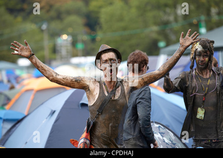 Boys playing in mud at music festival in the UK Stock Photo