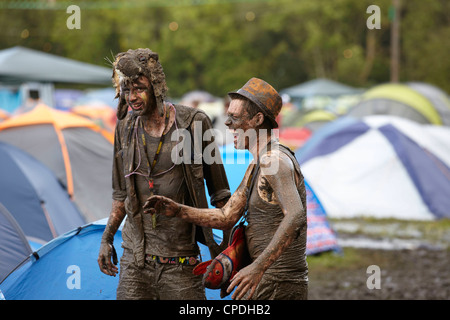 Boys playing in mud at music festival in the UK Stock Photo