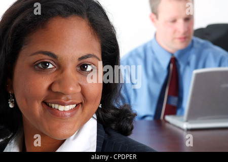 Woman with cell phone on a white background with man working in office Stock Photo