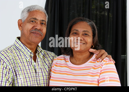 Senior Minority Couple Standing In Their Home Stock Photo