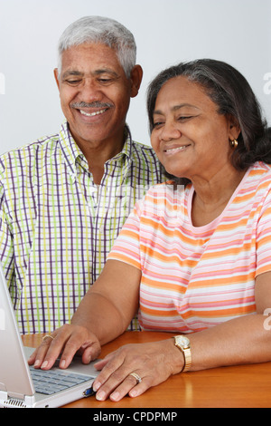 Senior Minority Couple Working On A Computer Stock Photo