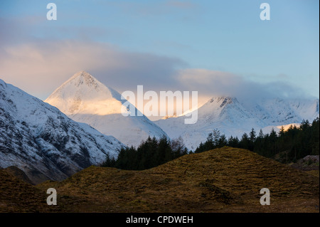 Shaft of golden sunlight on a snowy covered mountain, Glen Sheil, Highlands, Scotland, UK Stock Photo