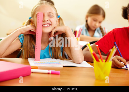 Portrait of lovely girl having fun at workplace at school Stock Photo