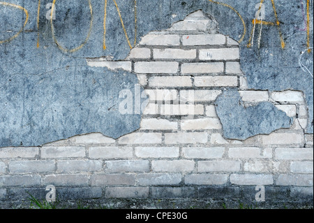 Background with old wall with bricks and cracked plaster Stock Photo