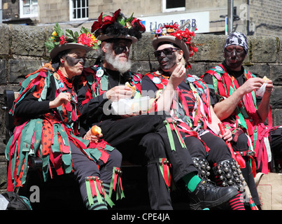 Four  members of FOXS Border Morris dancers take a break at Holmfirth Festival of Folk 2012 Stock Photo