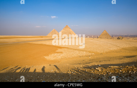 Late shadows of tourists at the viewpoint overlooking the Pyramids of Giza, with Cairo in the background, Egypt, Africa Stock Photo