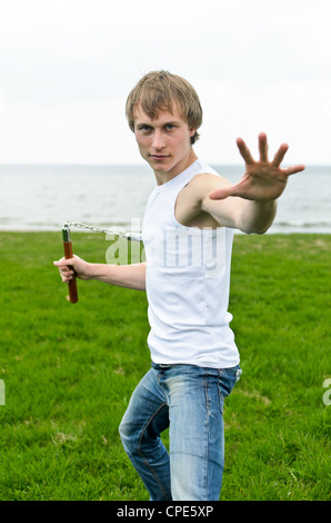 Martial arts: Man with nunchaku Stock Photo