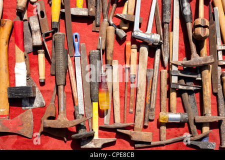 hand tools used rusty iron aged and grunge on a red background Stock Photo