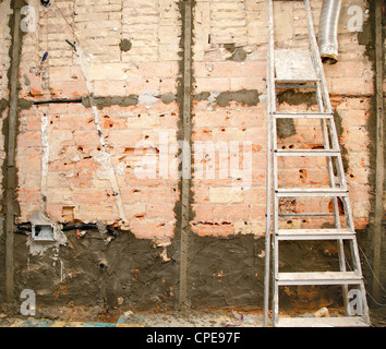 demolition before tiling in kitchen interior construction and ladder Stock Photo