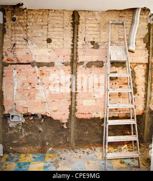 demolition debris in kitchen interior construction and ladder Stock Photo