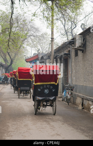 Rickshaw drivers take tourists for Hutong tour, Beijing, China Stock Photo