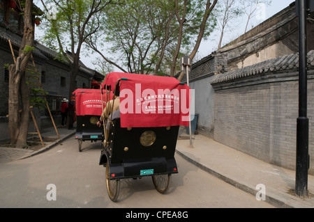 Rickshaw drivers take tourists for Hutong tour, Beijing, China Stock Photo