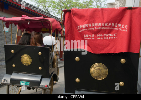 Rickshaw drivers take tourists for Hutong tour, Beijing, China Stock Photo