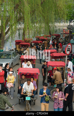 Rickshaw drivers take tourists for Hutong tour at Hou Hai Lake, Beijing, China Stock Photo