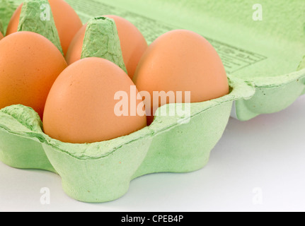 Brown eggs in a green carton Stock Photo