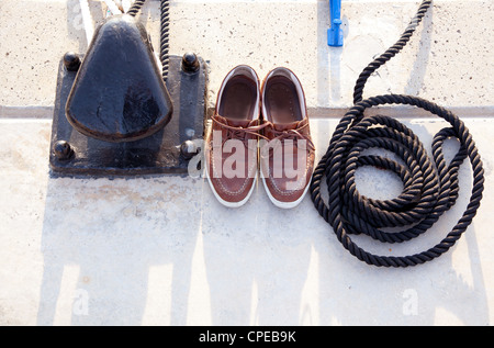 Bollard with nautic shoes and rope coil on mooring marina Stock Photo