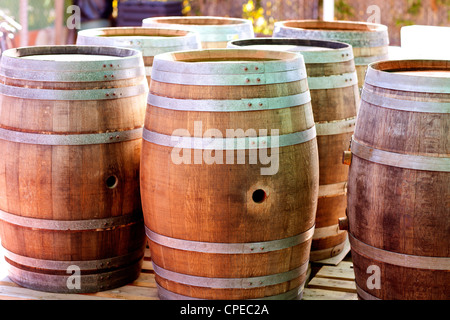 barrels of oak wood for wine or liquor in a row Stock Photo