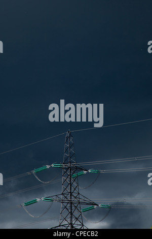 Electricity Pylon and power cables against dark stormy sky,England Stock Photo