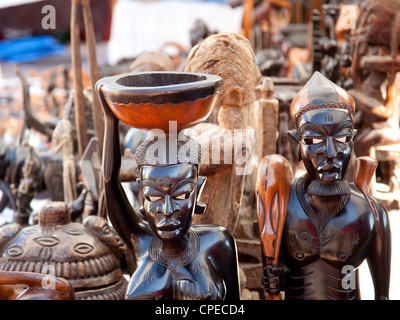 african handcraft dark wood carved people figures Stock Photo