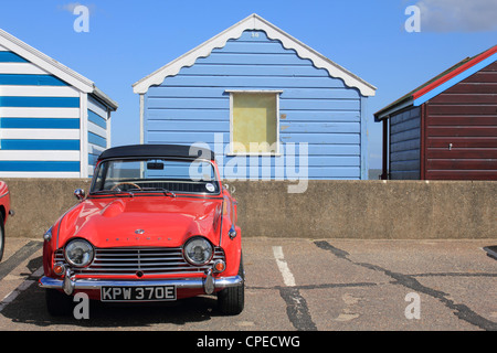 Colourful beach huts and Triumph TR4 at the famous coastal resort of Southwold Suffolk England UK Stock Photo