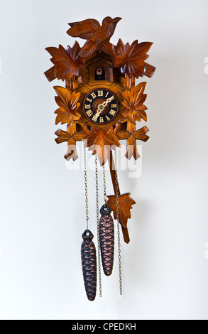 Family cuckoo clock with metal pine cones Stock Photo