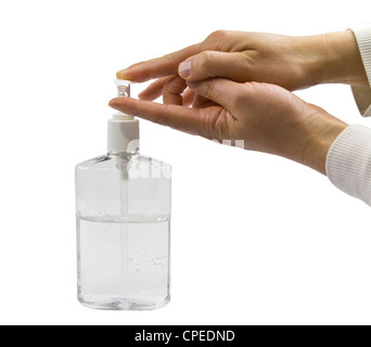 Clear bottle of hand sanitizer with two hands in use Stock Photo
