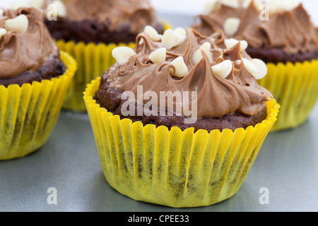 Chocolate cupcakes with milk chocolate frosting and white chocolate chips. Stock Photo