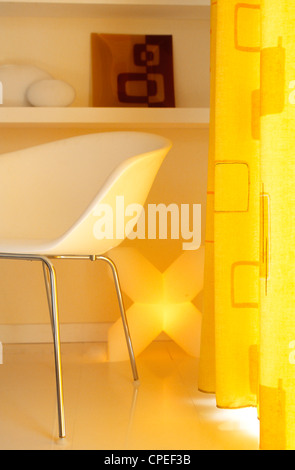 Easy Chair Beside Yellow Curtain Stock Photo