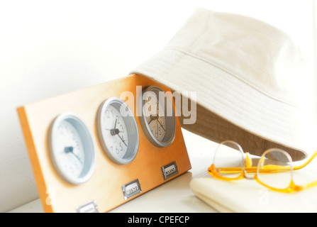 Close Up View Of Clock, Cap And Spectacles On Table Stock Photo