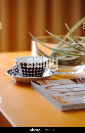 Teacup, Saucer, Glass Bowl And Magazine On Table Stock Photo