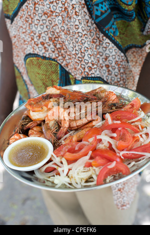 Waiter with plate of food on Mogundula island in the Quirimbas archipelago in northern Mozambique. Stock Photo