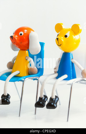 Plastic Toys On Chair On White Background Stock Photo