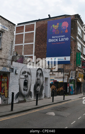 Advertisement for "Banglatown Curry Capital 2012" in Hanbury St, off Brick Lane, London covering street art by the artist Roa. Stock Photo