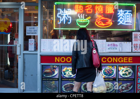 Woman looking at menu in Chinatown New York City Stock Photo