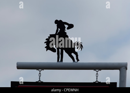 A silhouette cutout of a cowboy riding a bucking horse Stock Photo