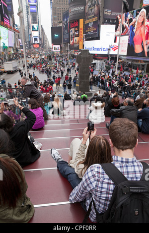 People hang out and enjoy the atmosphere of Times Square in New York City. Stock Photo