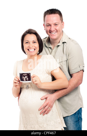 Portrait of happy laughing pregnant couple showing ultrasound picture of baby, isolated on white background. Stock Photo