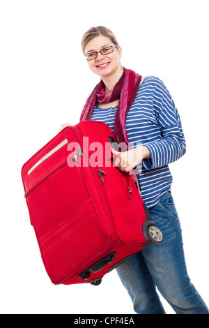 Young happy woman travelling with large red luggage, isolated on white background. Stock Photo