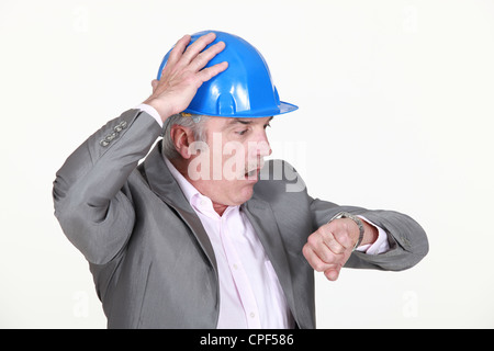 mature architect consulting his watch Stock Photo