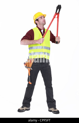 Worker using bolt cutters Stock Photo