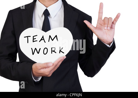 Businessman holding paper written teamwork in hand Stock Photo