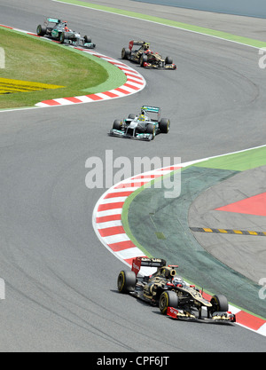four cars race through curve during the Formula 1 Grand Prix of Spain ...