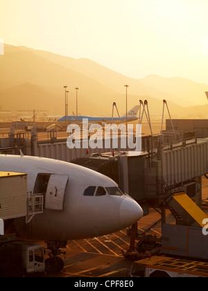 A sunset view of airplanes taking off at the Hong Kong International Airport on New Years Eve. December 31, 2010. Stock Photo