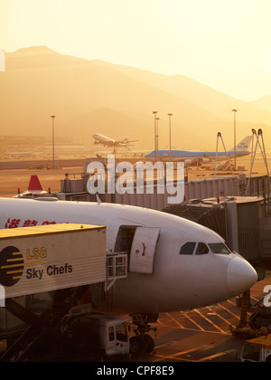 A sunset view of airplanes taking off at the Hong Kong International Airport on New Years Eve. December 31, 2010. Stock Photo