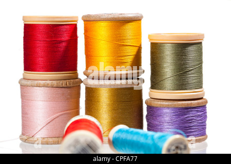 Sewing threads on bobbins in different colours Stock Photo