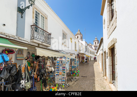 Shops on Rua Henrique Correia da Silva with Igreja de Santo Antonio in distance, Old Town, Lagos, Algarve, Portugal Stock Photo