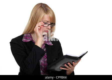 Businesswoman looking at her agenda Stock Photo
